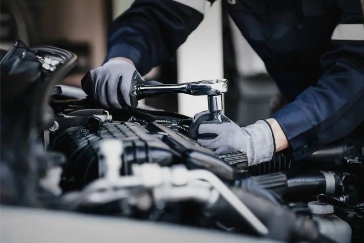 Automotive mechanic working under a car